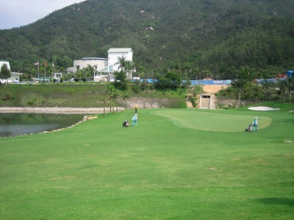 the 9th green with a lake on its left from the fairway